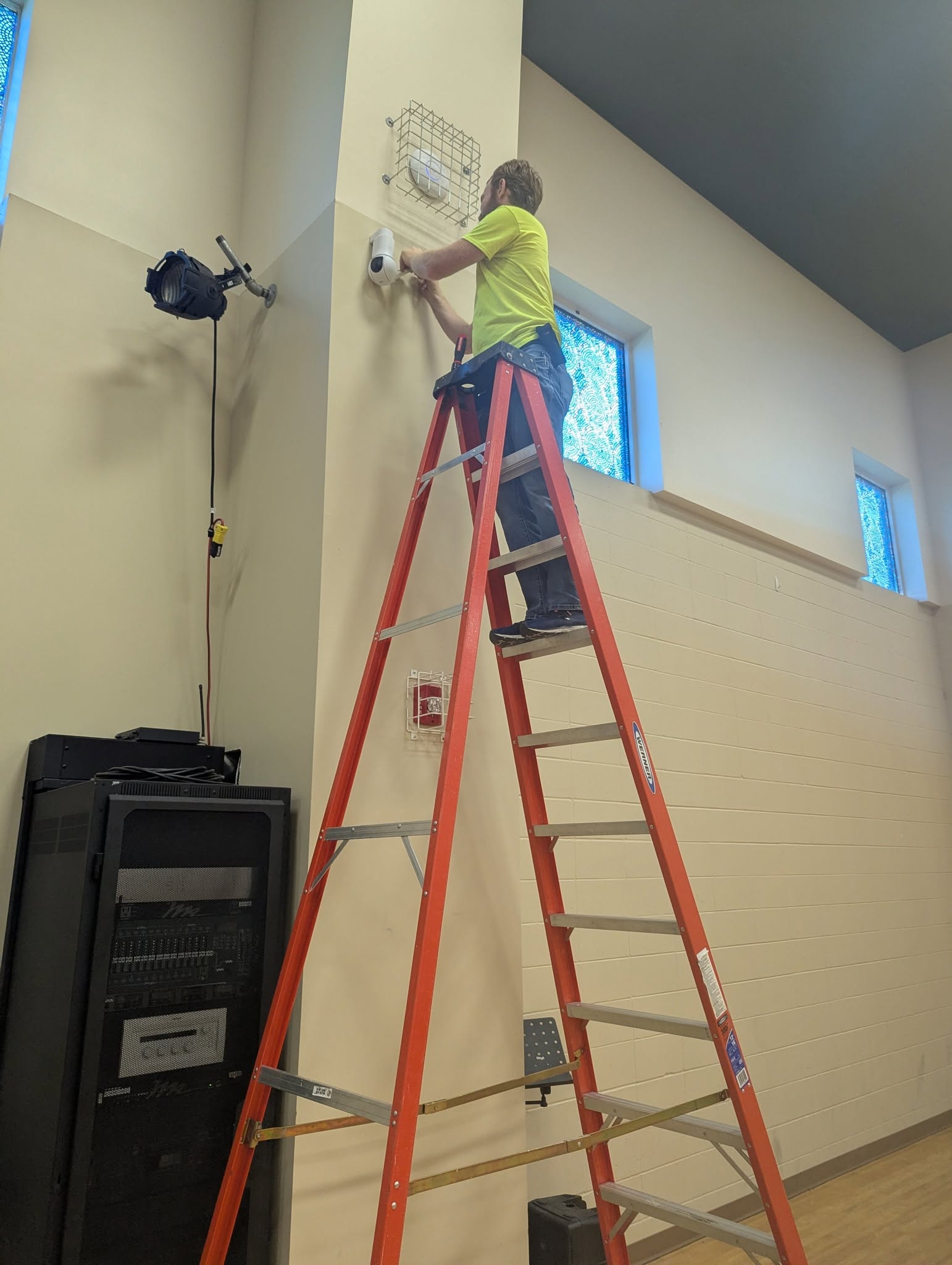 Hammer Brothers technician working on a wall-mounted network installation